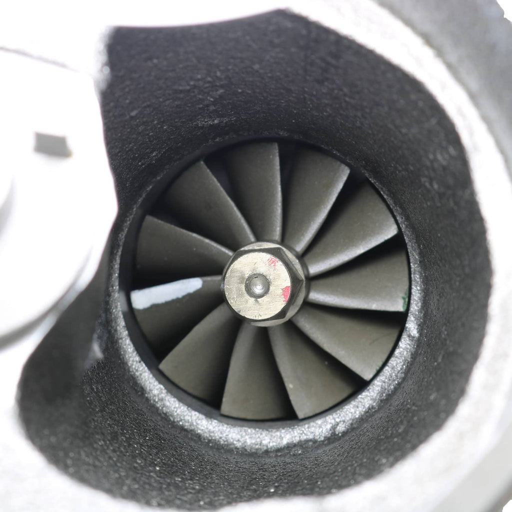 Turbo charger turbine wheel with dark blades and central metal hub