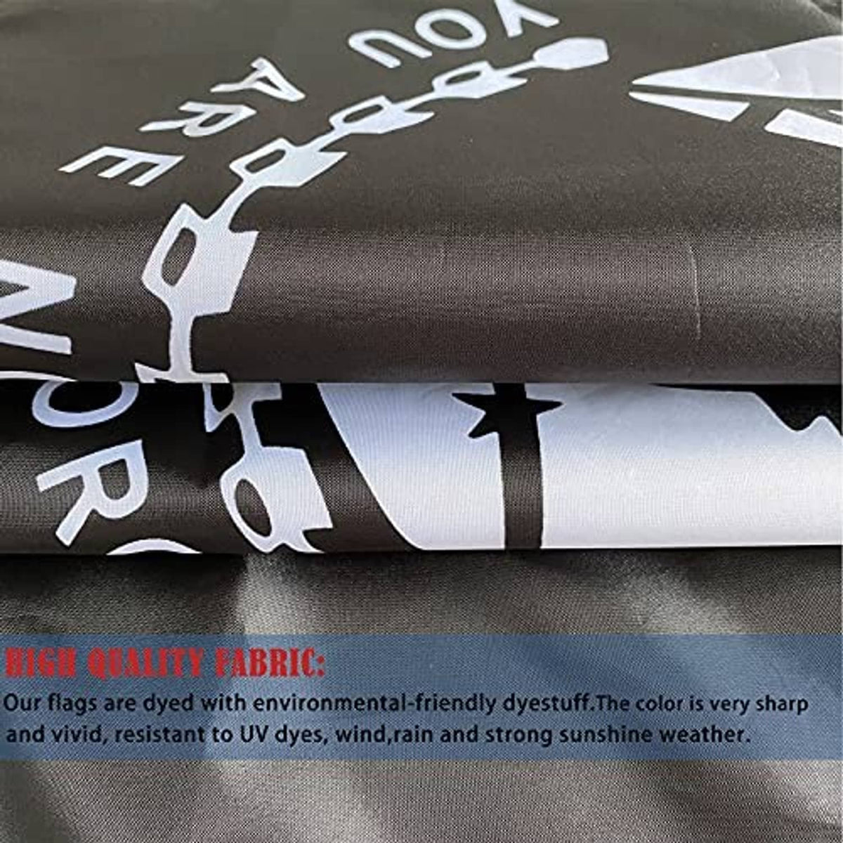 Close-up of woven black and white flag fabric with partial POW-MIA print, rolled