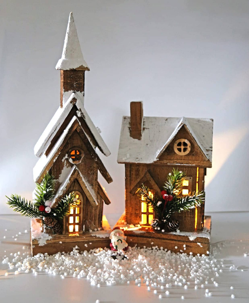 Mini lit Christmas village house decorations with warm LED night lights and greenery