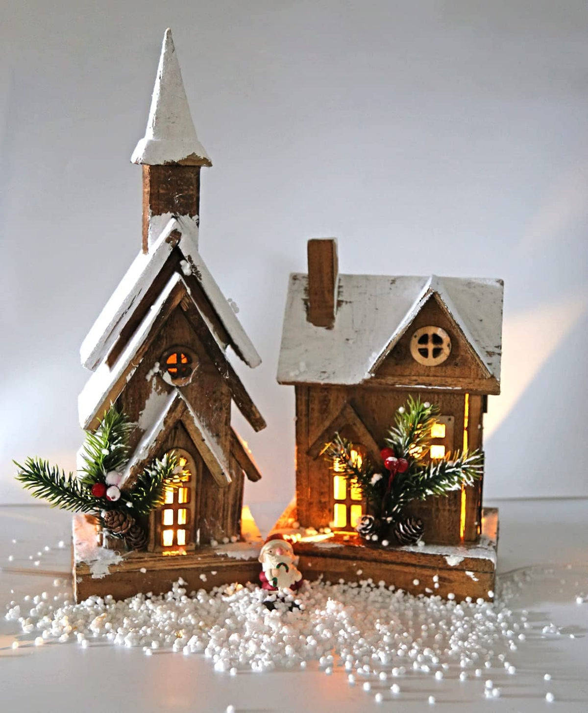 Mini lit Christmas village house decorations with warm LED night lights and greenery