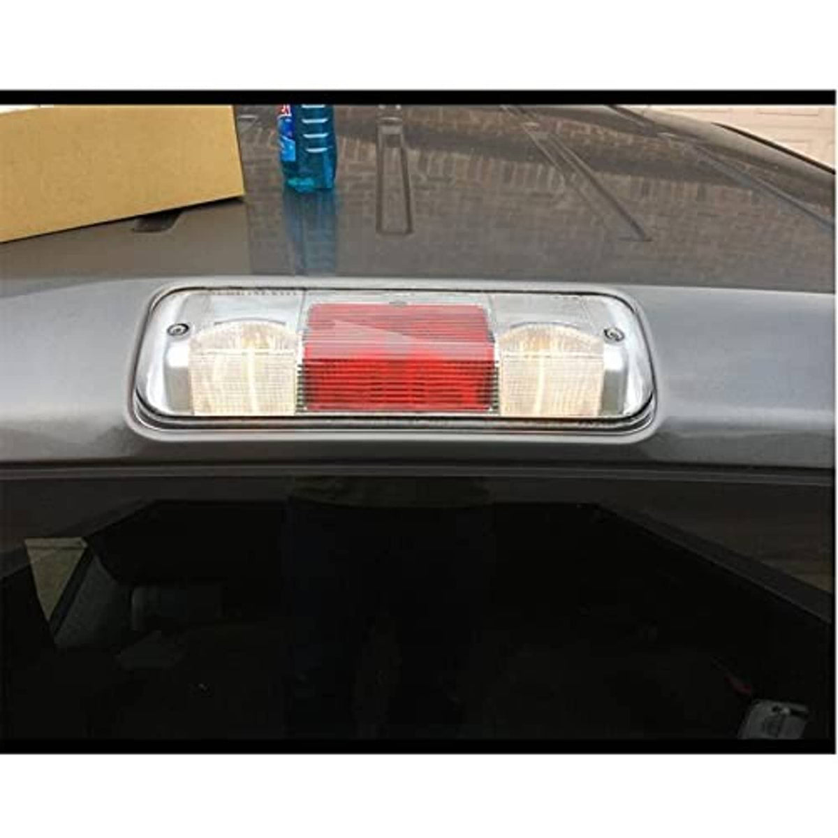 Mounted rear center brake light lamp on vehicle panel, clear and red lens