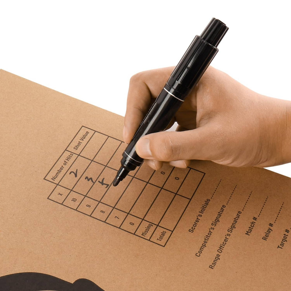 Highwild cardboard target with scoring grid marked by pen, black silhouette target face