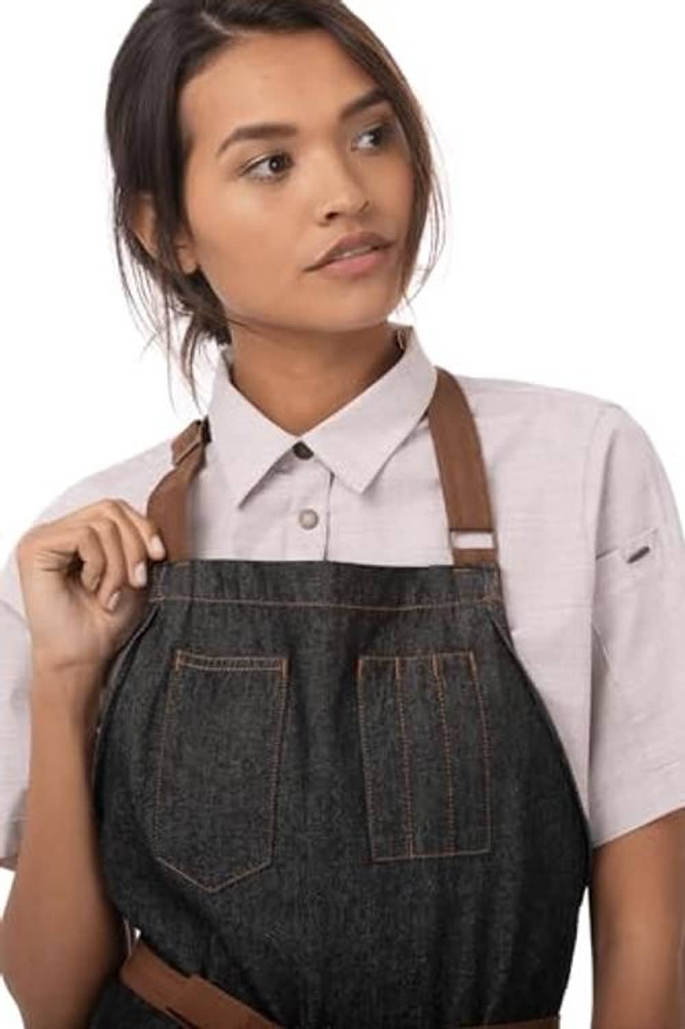 Dark bib apron close-up with square chest pocket and brown neck straps