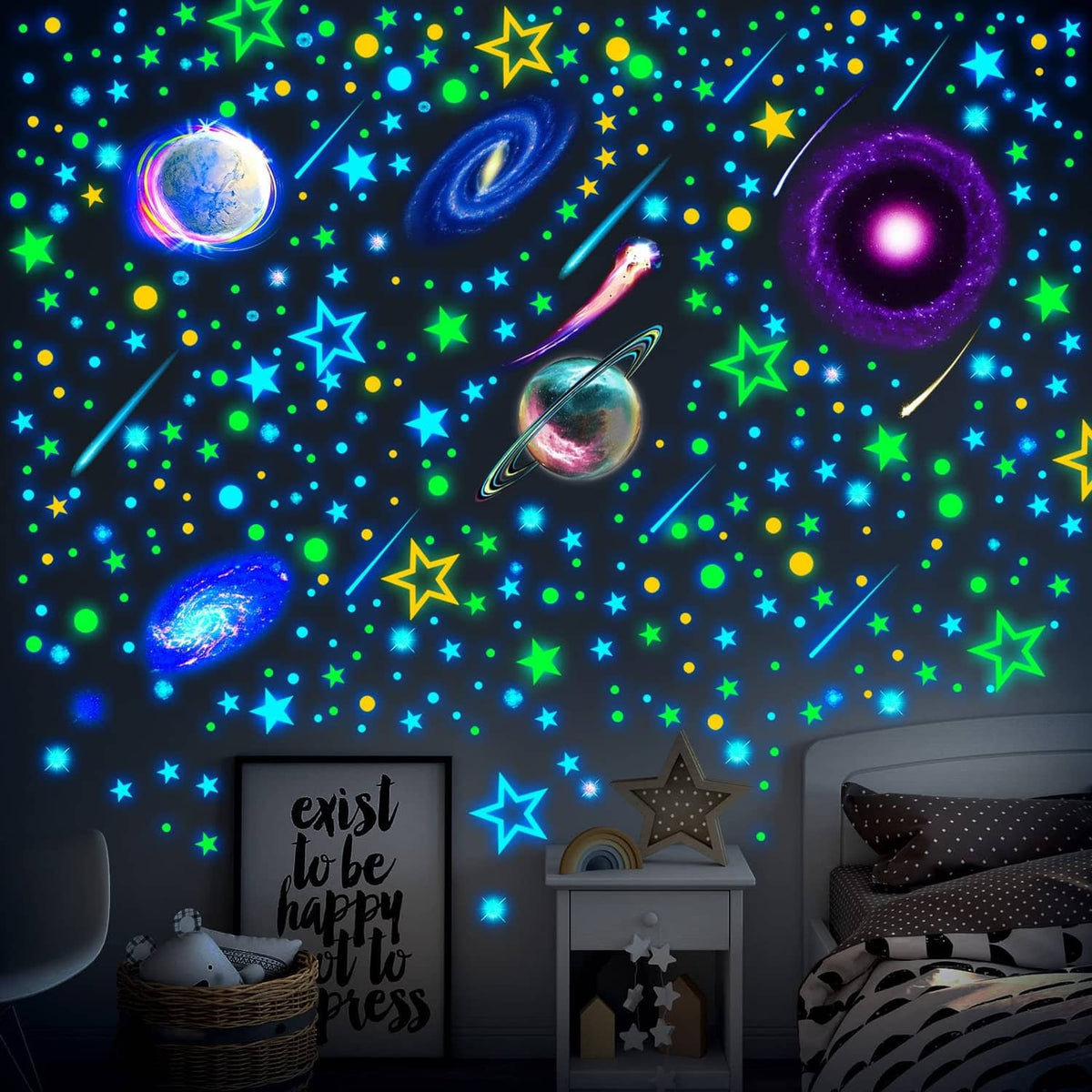 Glow-in-the-dark space star and planet wall decals on a bedroom wall with scattered icons