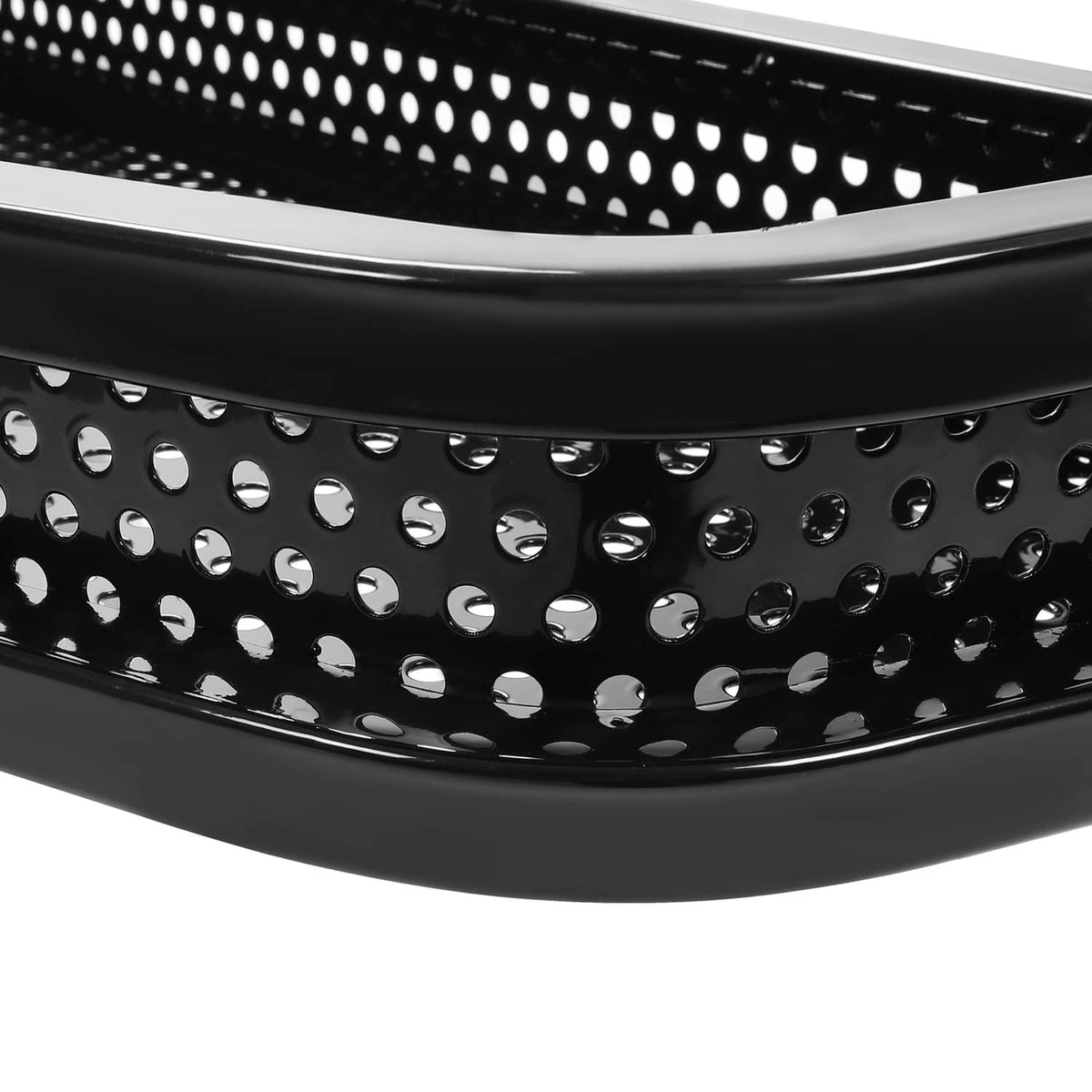 Close-up of black perforated metal basket panels with rounded edge trim