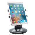 Tablet stand with black round base and gray adjustable side clamps holding a tablet