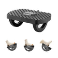 Black under-desk footrest with textured massage nubs and three-roller curved base