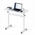 Uimoso adjustable height mobile standing desk with white top, casters, and phone/laptop setup