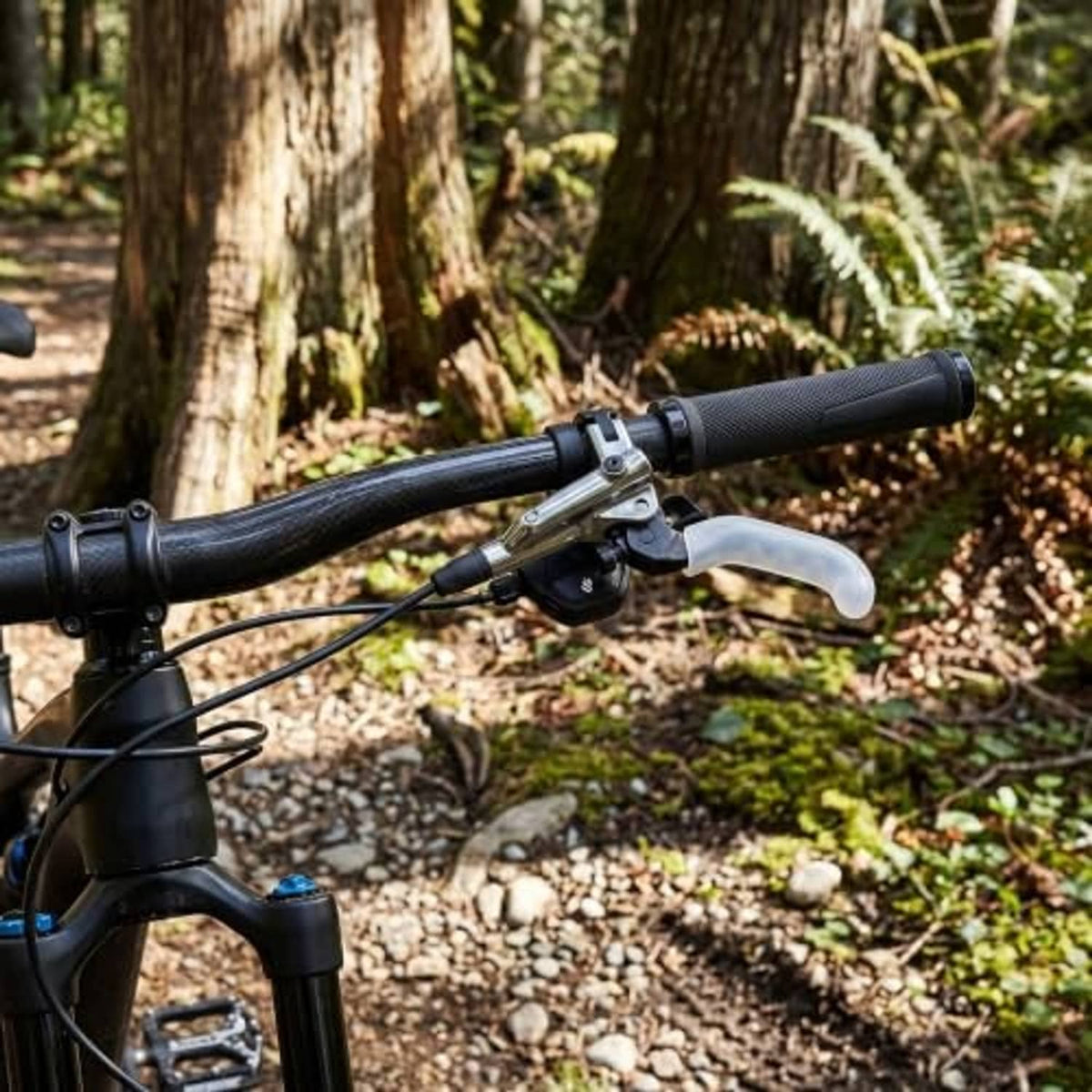 Installed white silicone brake lever grips on a bicycle brake handle
