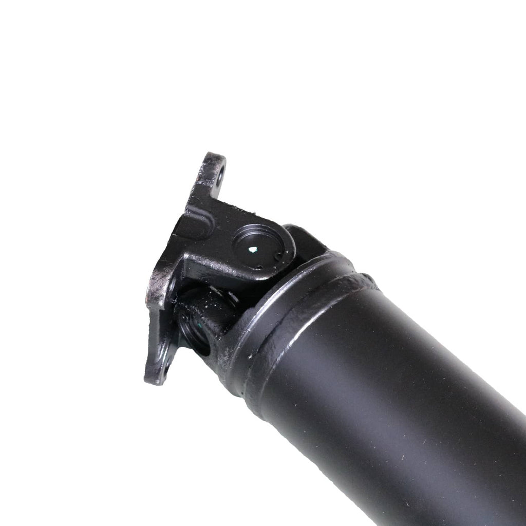 Black prop shaft universal joint with metal yoke and circular center bushing.