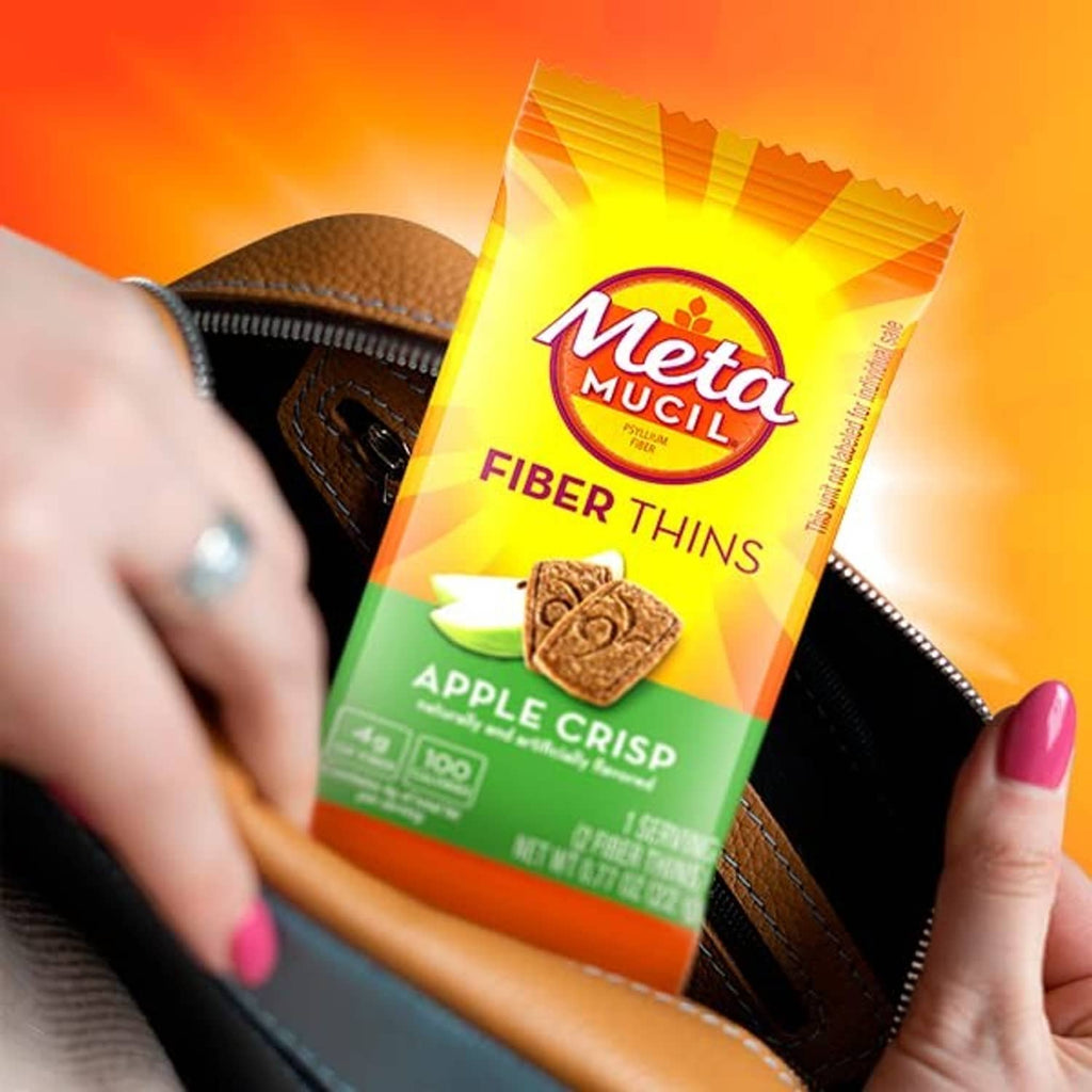 Metamucil Fiber Thins apple crisp packet held in wallet by hands