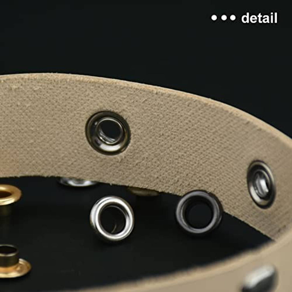 Close-up of grommet eyelets on beige fabric with metal ring fasteners