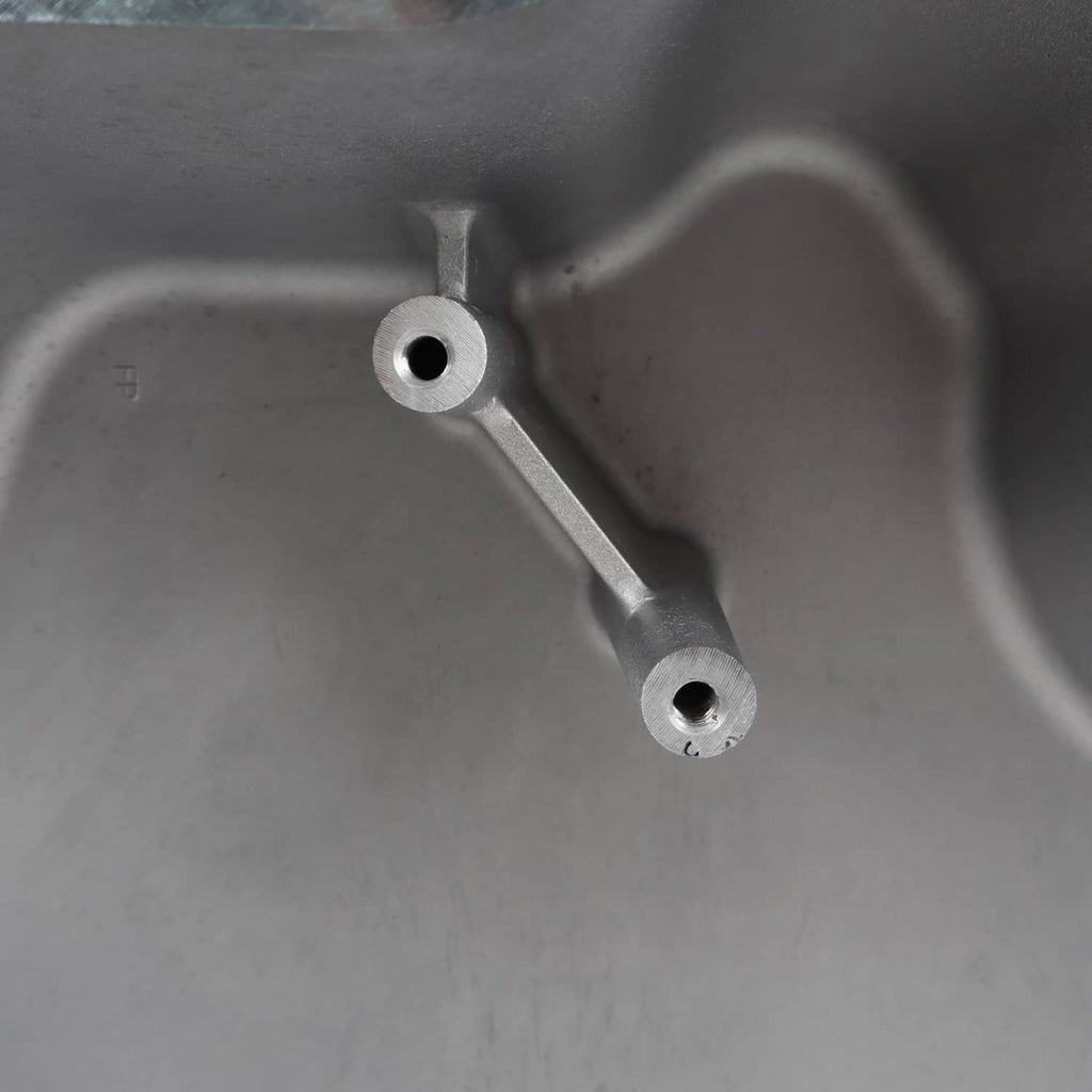 Oil pan interior showing metal support brackets and round holes