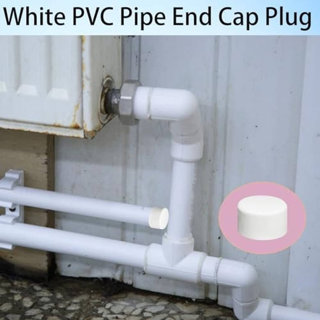 White PVC pipe end cap plug on elbow pipe joint, round sealed cap end