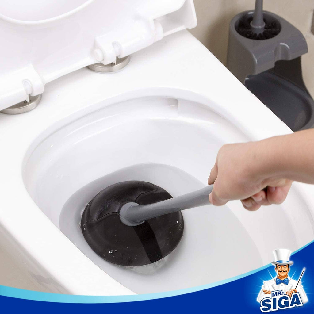 Toilet plunger cup pressed into the bowl drain area for clog clearing