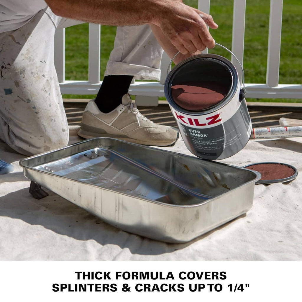 Coating can and paint roller used on deck boards, with metal tray on drop cloth