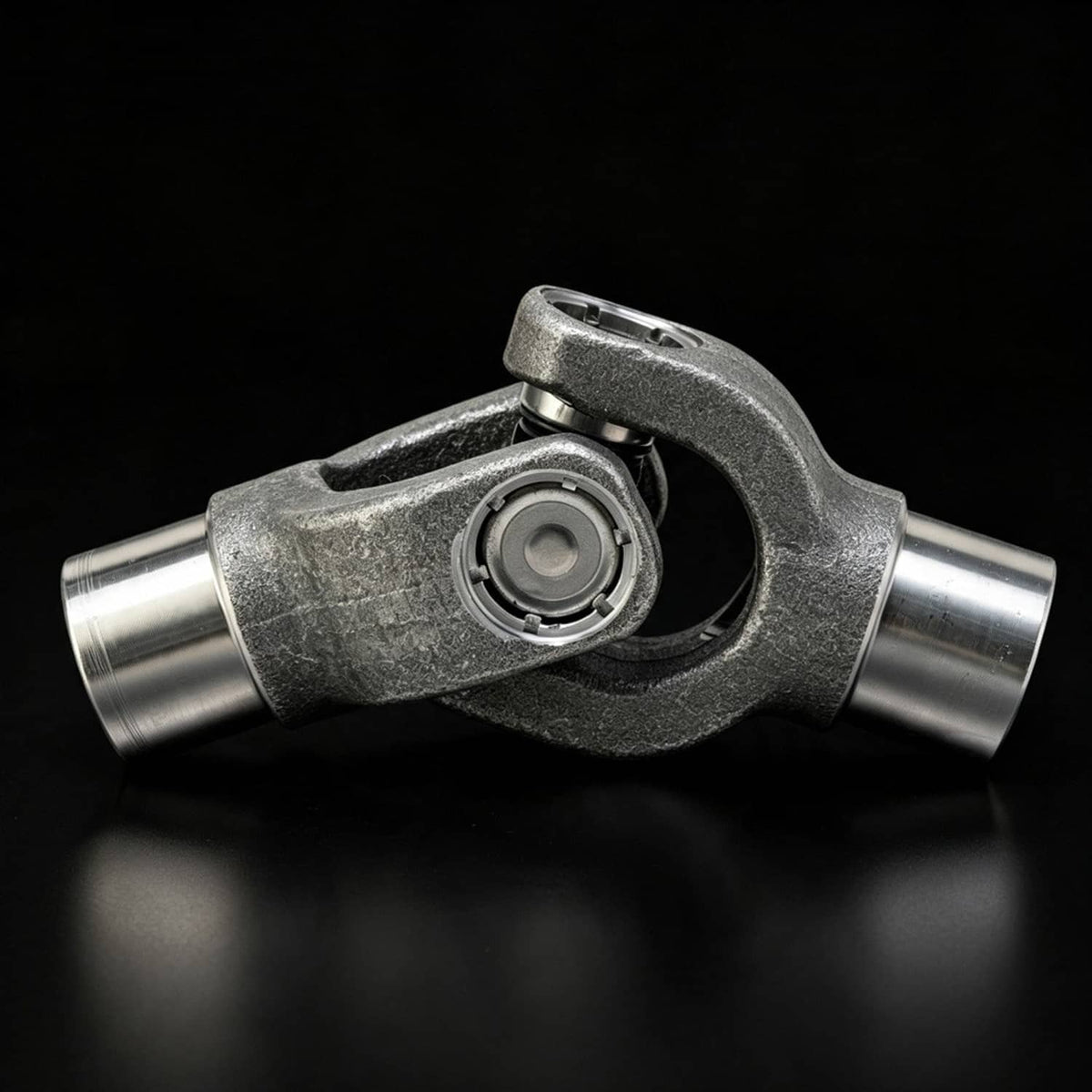 Metal drive shaft yoke with circular U-joint bearing and cross housing