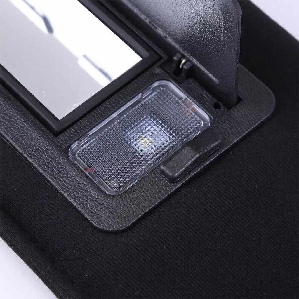 Close-up of LED light lens on black sun visor vanity mirror
