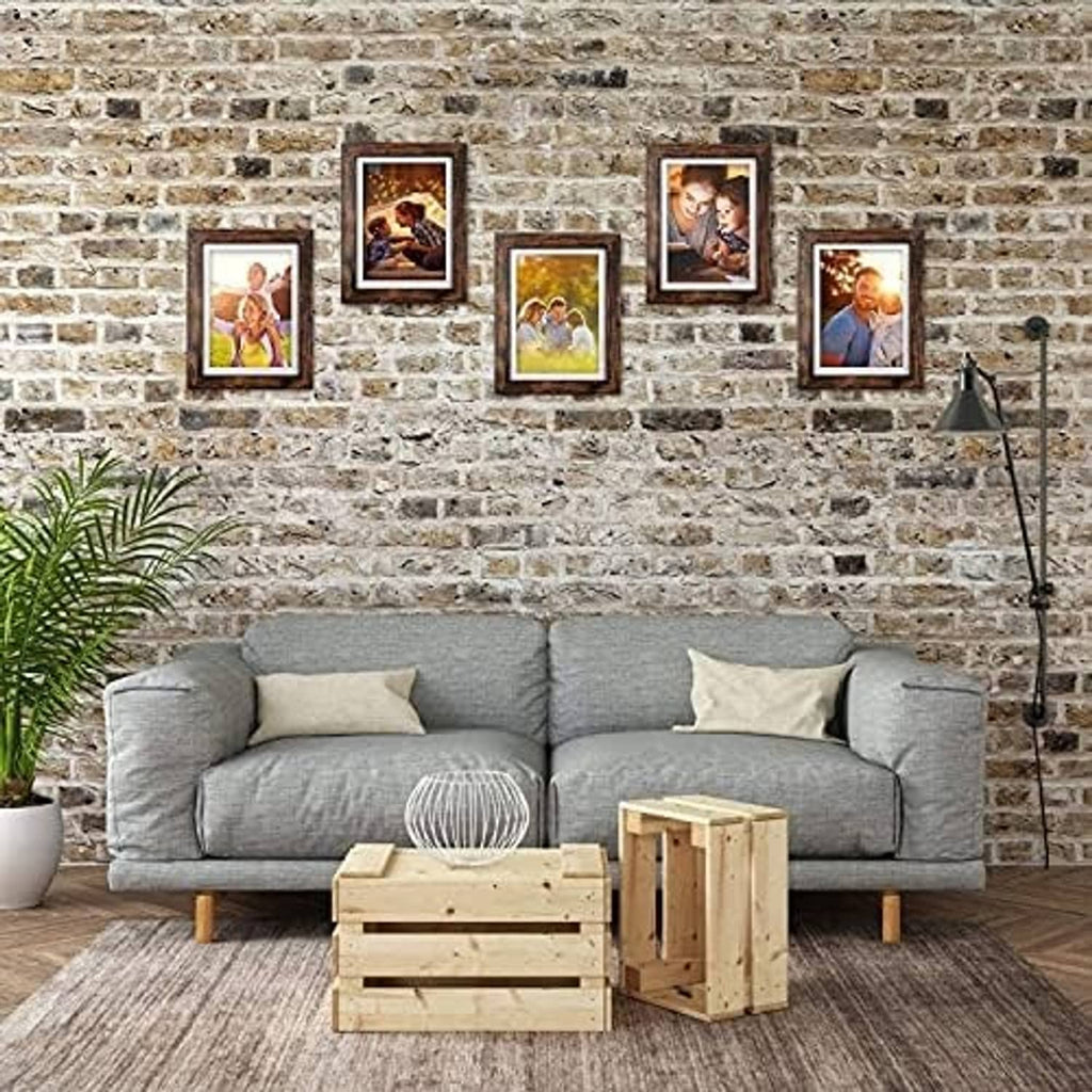 Rustic brown wood picture frames arranged on wall with multiple portrait photos