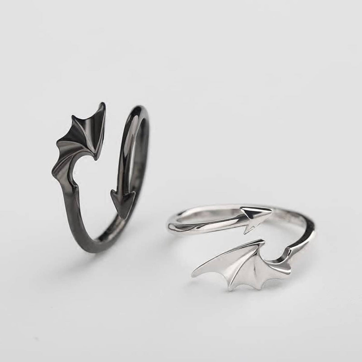 Silver bat-wing and lightning rings set shown on a light background