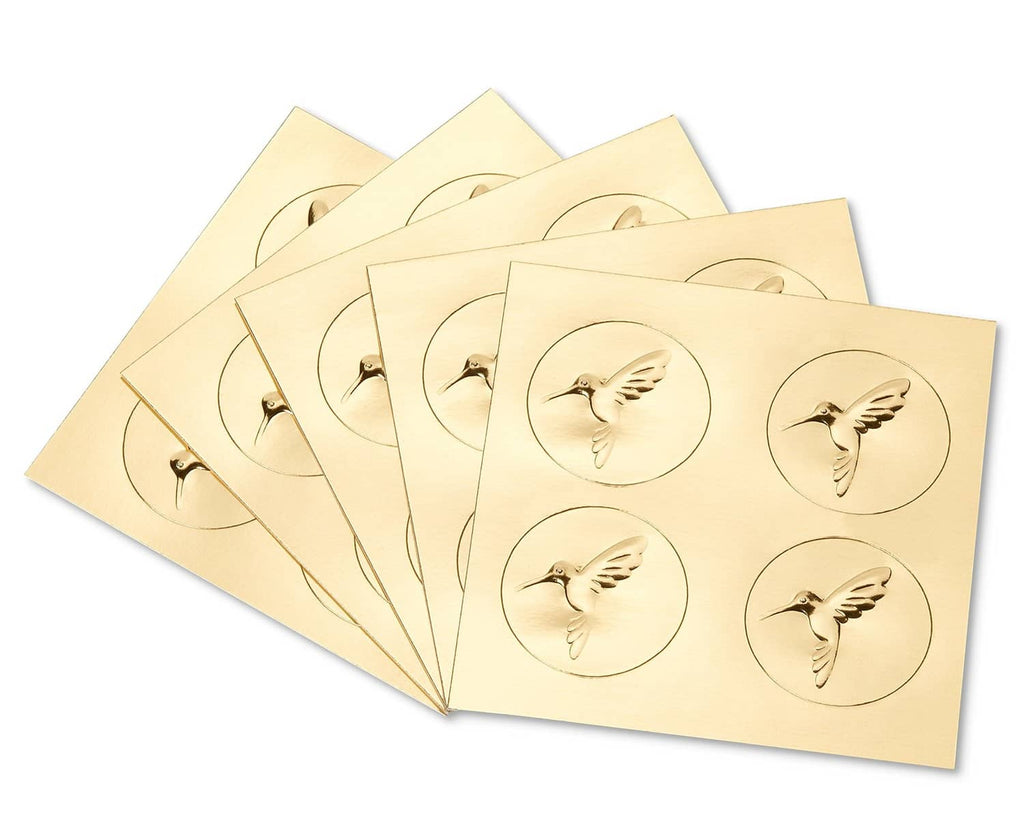 Gold embossed note cards with bird medallion designs, stack of several cards