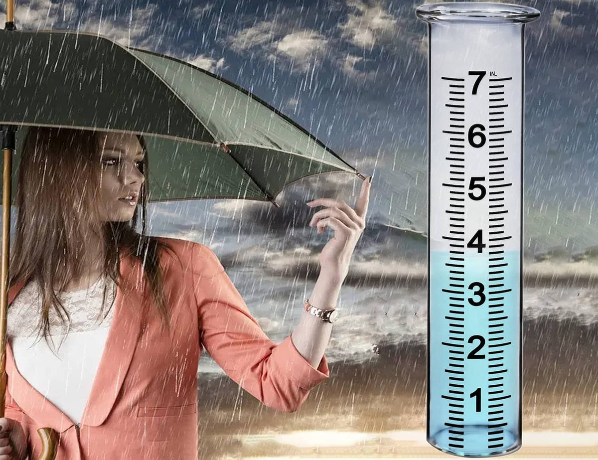 Glass rain gauge replacement tube beside falling rain, with 1–7 inch scale