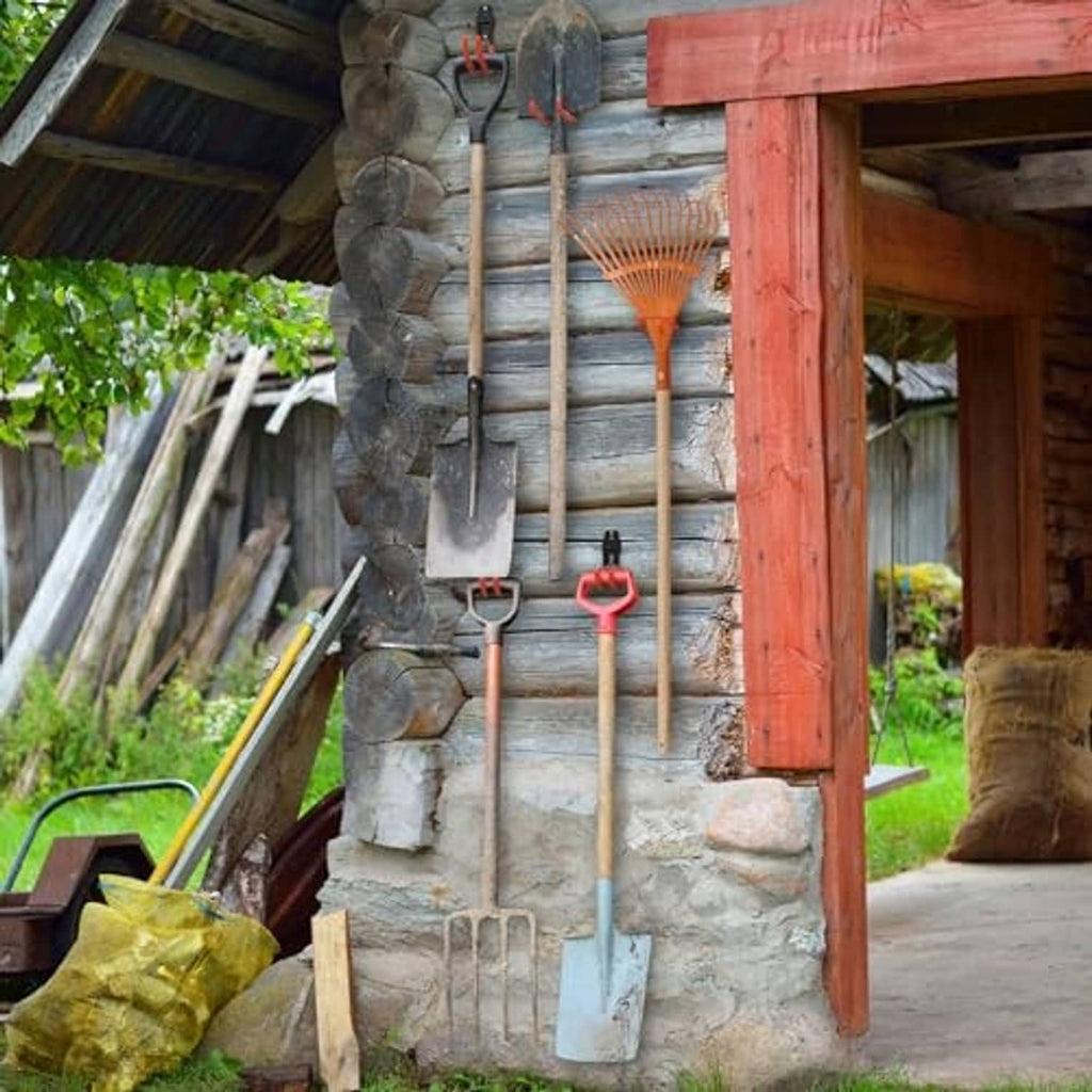 Garage storage hooks holding tools on wooden beams and stone wall