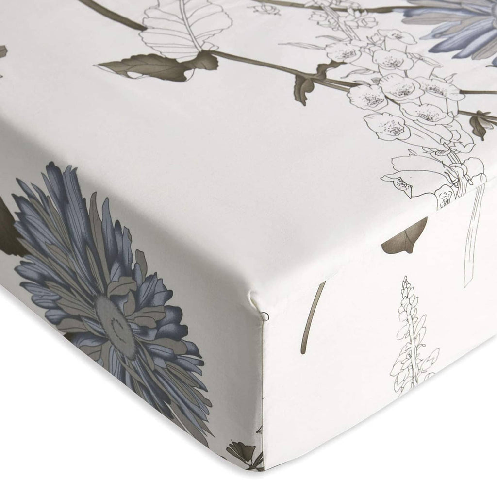 White fitted bed sheet corner with blue floral and vine botanical pattern