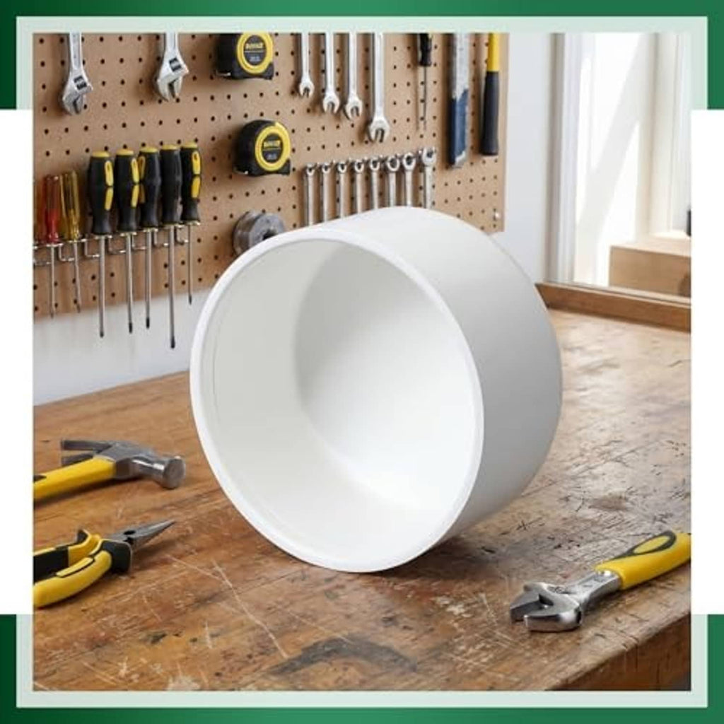 White PVC pipe end cap shown from the open interior on a workbench