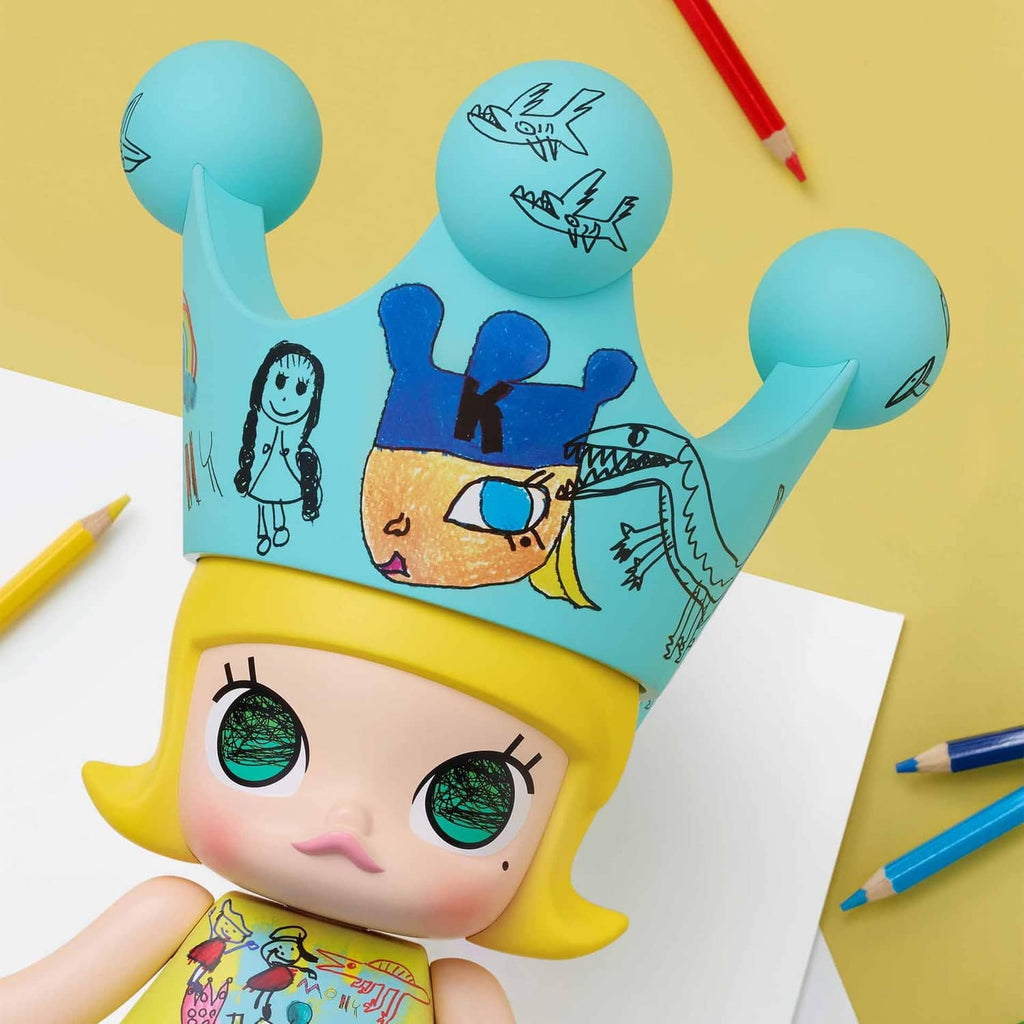 Royal Molly collectible doll close-up, teal crown and yellow face with green eyes
