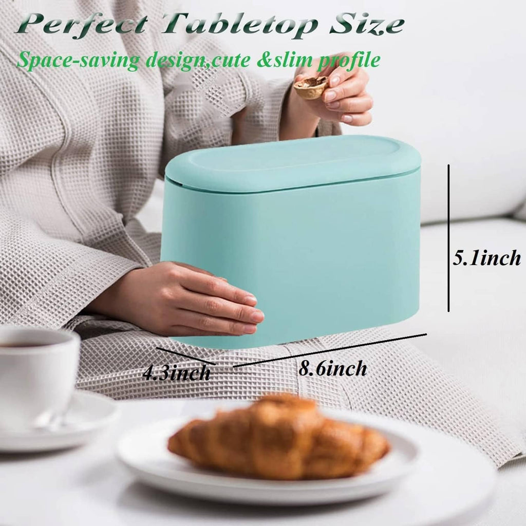 Light blue mini trash can with closed lid next to a plate on a couch table