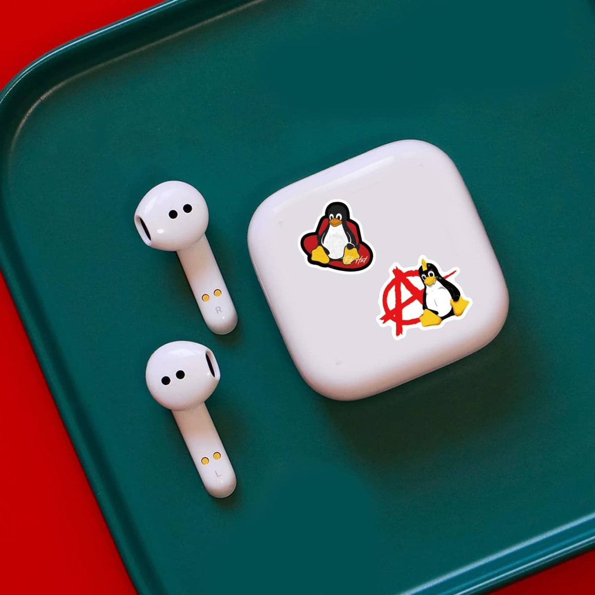 Small Linux penguin stickers on white wireless earbuds case