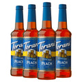 Set of 4 sugar-free peach syrup bottles with blue caps and amber labels