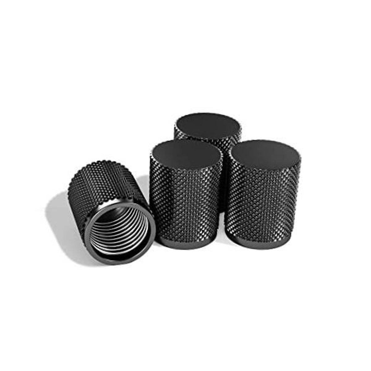 Set of 4 black textured tire valve caps with threaded openings, CNC-style cylinders