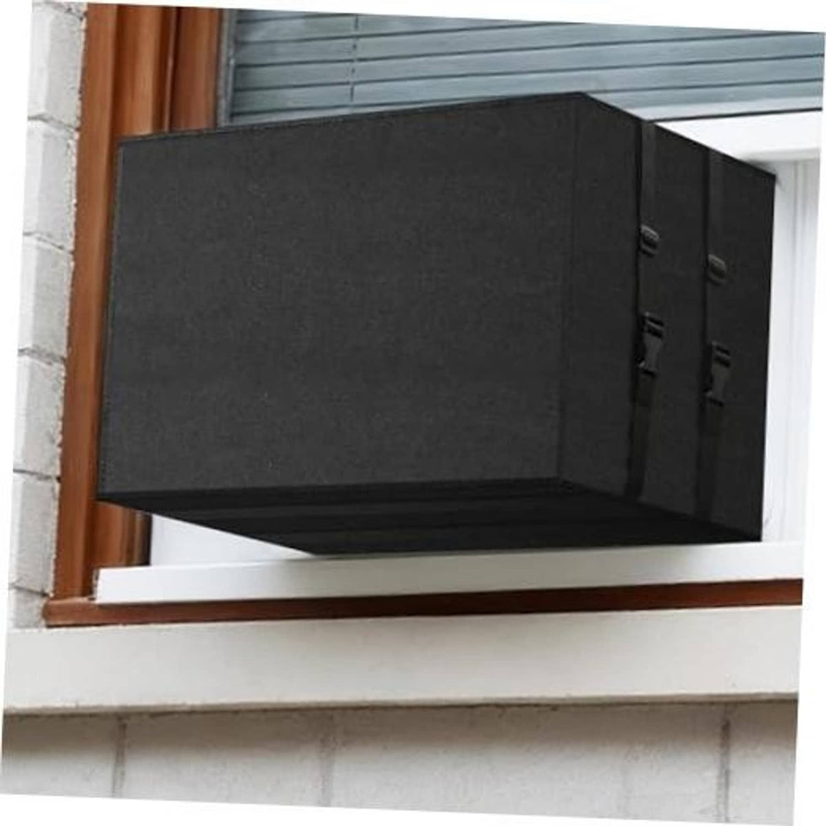 Black rectangular AC cover for outside window unit with side strap panels, installed.