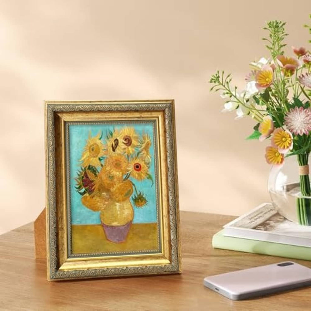 Ornate gold 5x7 picture frame with sunflower artwork behind clear glass