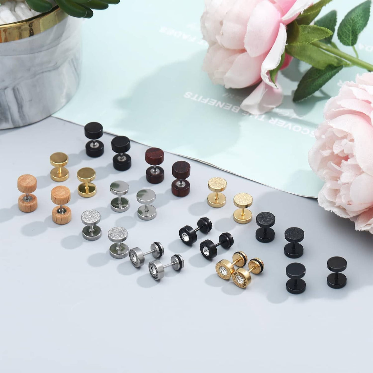 12 pairs of stud earrings with mixed round finishes, including metal, textured, and wood-look