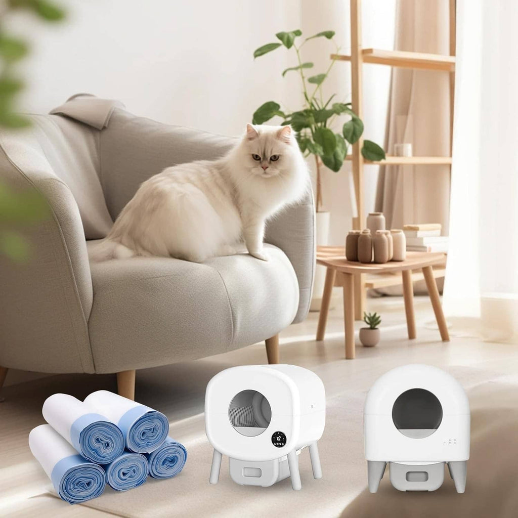 White cat litter box with blue liner rolls on the floor near a white cat