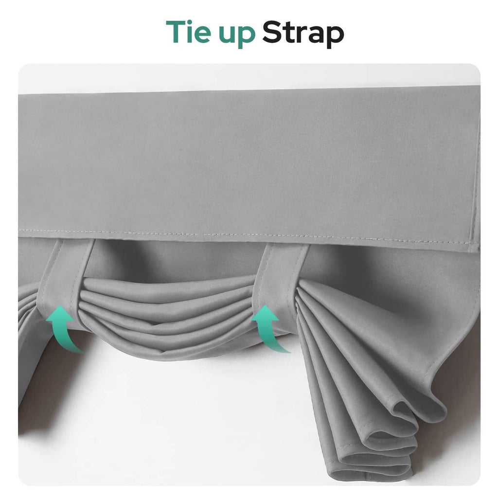 Light grey blackout curtain panel with tie-up strap and gathered bottom fold