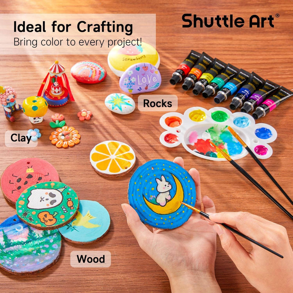 Acrylic paint set tubes with crafting tools and painted wood decorations