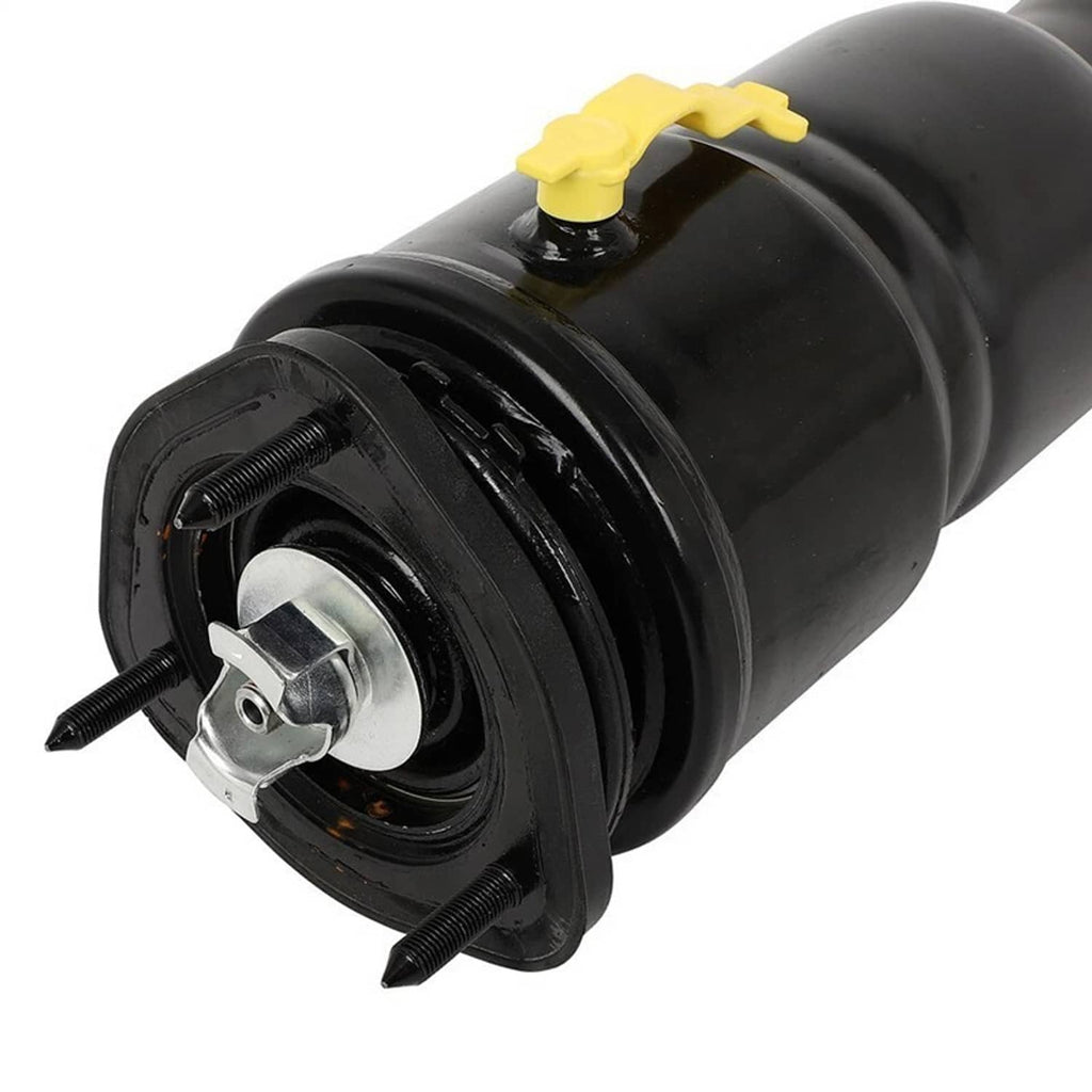 Close-up of black air shock strut top mount with yellow service cap and metal stud plate