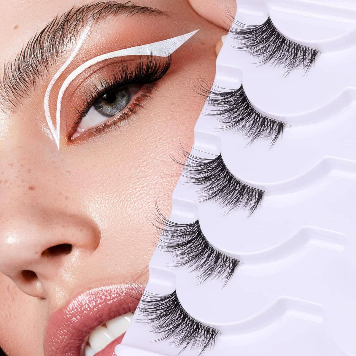 Wispy false eyelashes with clear band being applied on an eye, natural look style