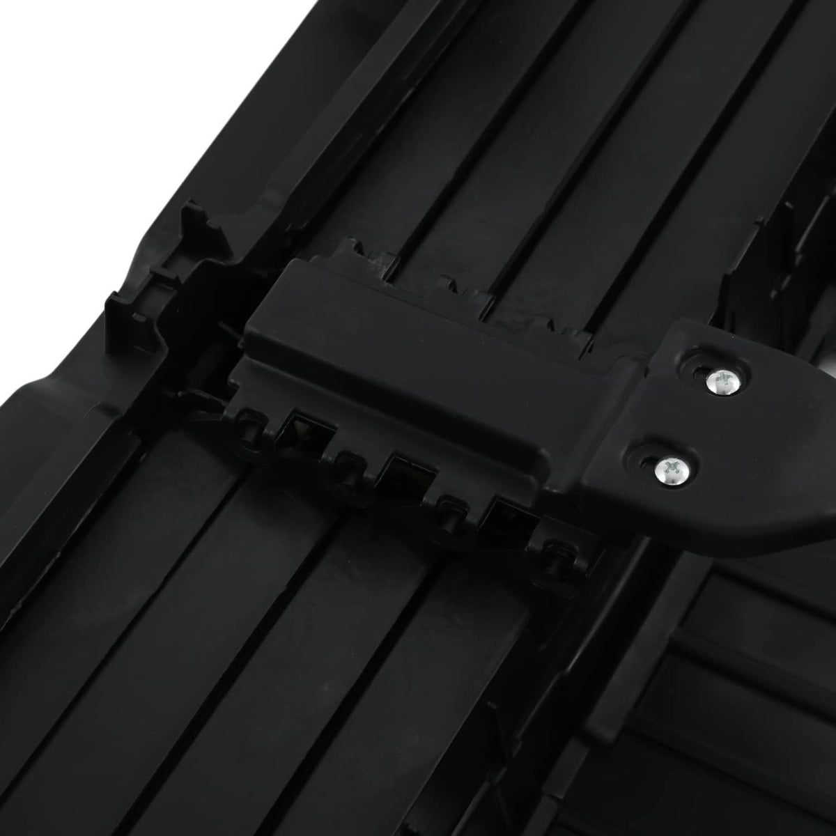 Close-up of black shutter assembly with mounting clip and screw-fastened plate