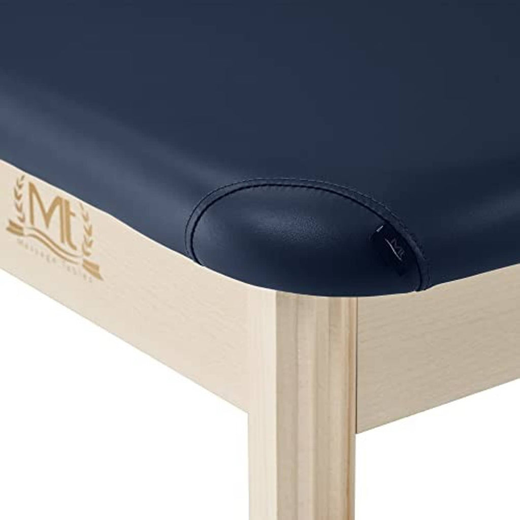 Stationary treatment table padded top close-up with stitched dark blue vinyl