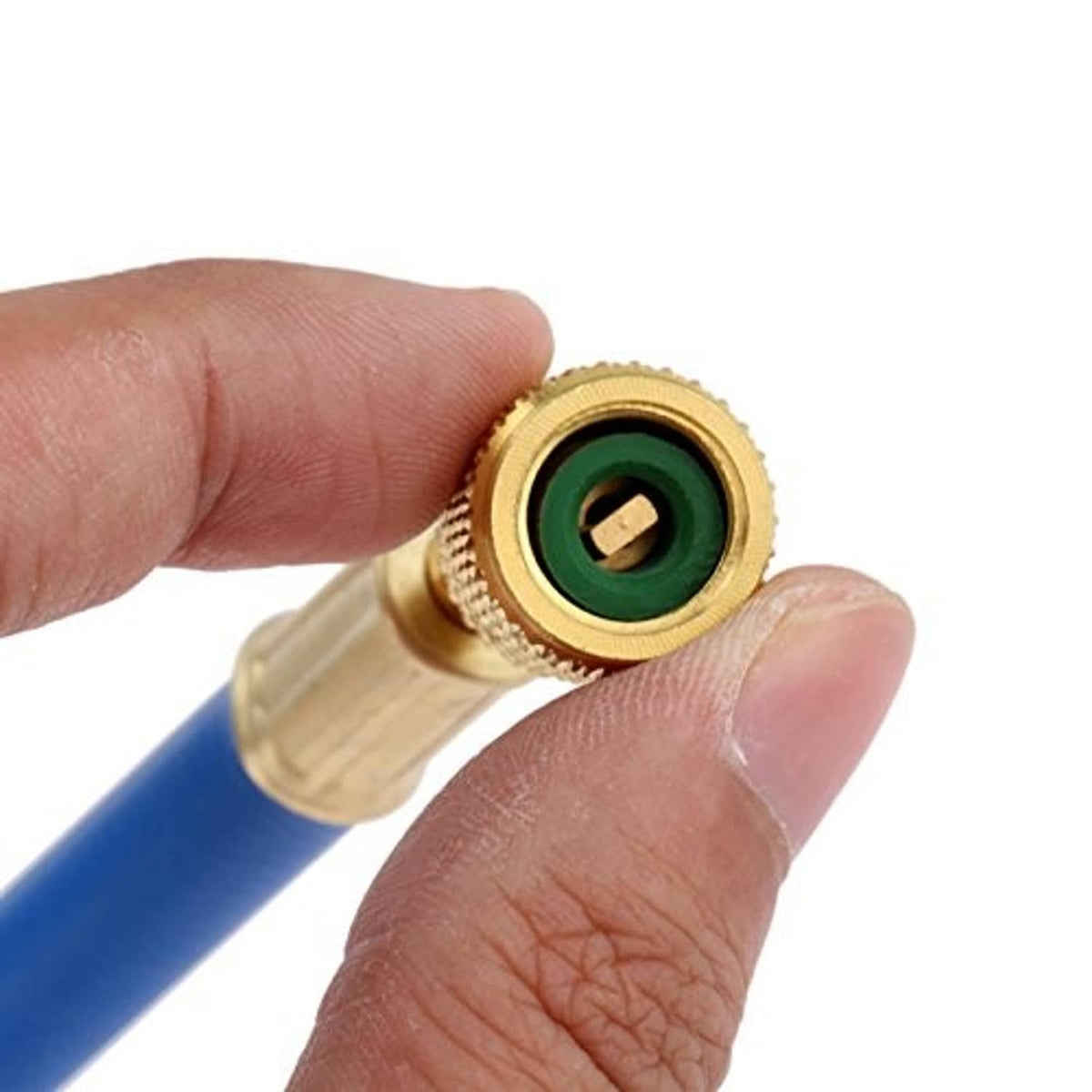 Close-up brass charging hose fitting with green seal, held by a hand