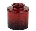 Red speckled ceramic butter crock with domed lid, glossy glaze.