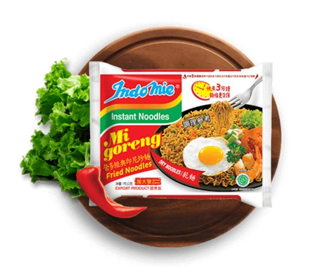 Indomie Mi Goreng noodle pack on plate with fried egg and vegetables