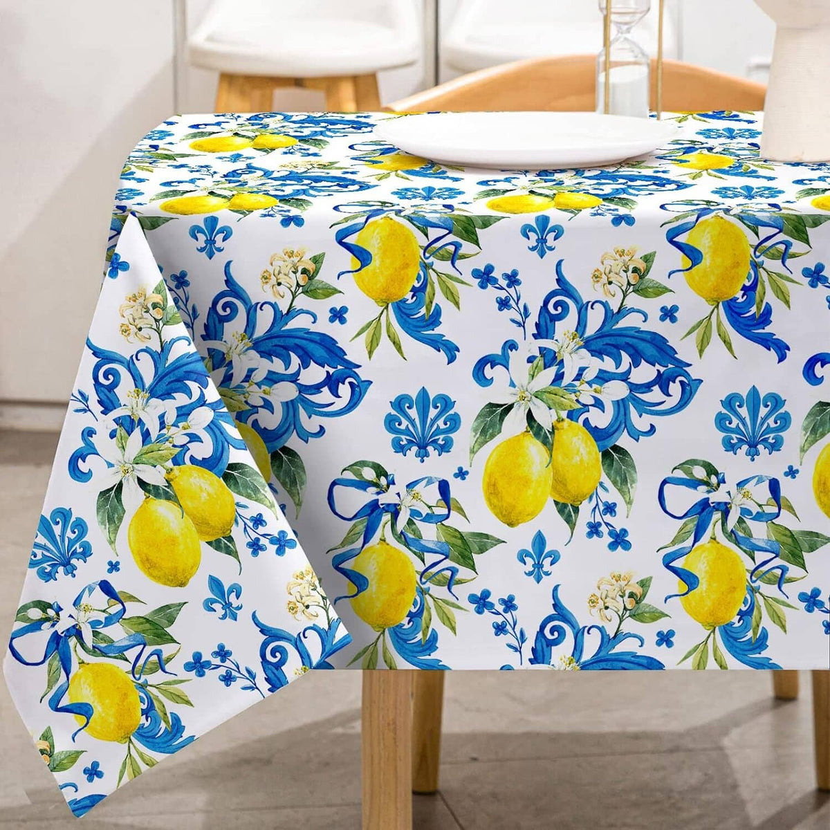 White tablecloth with blue floral swirls and yellow lemon pattern, draped over table