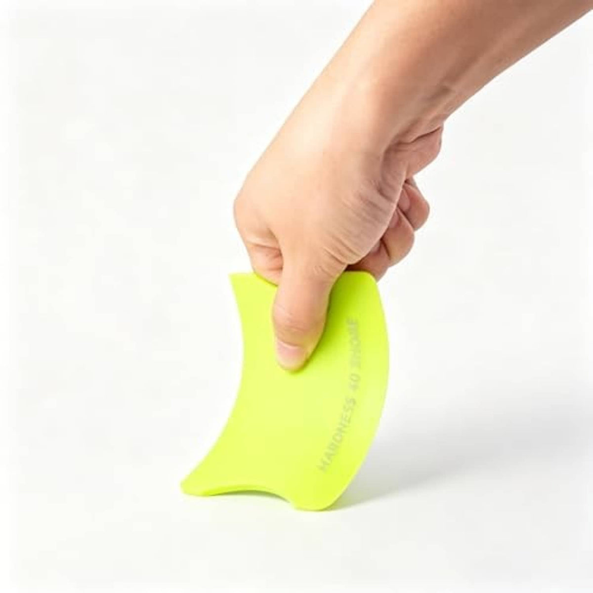 Lime green vinyl squeegee in hand, rounded blade for applying vinyl