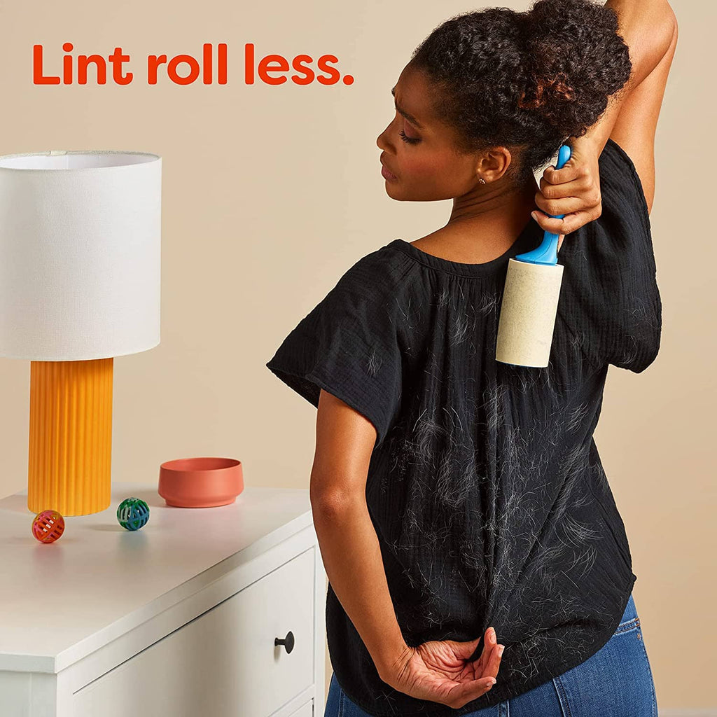 Unscented pet hair & lint guard dryer sheet in hand for laundry use